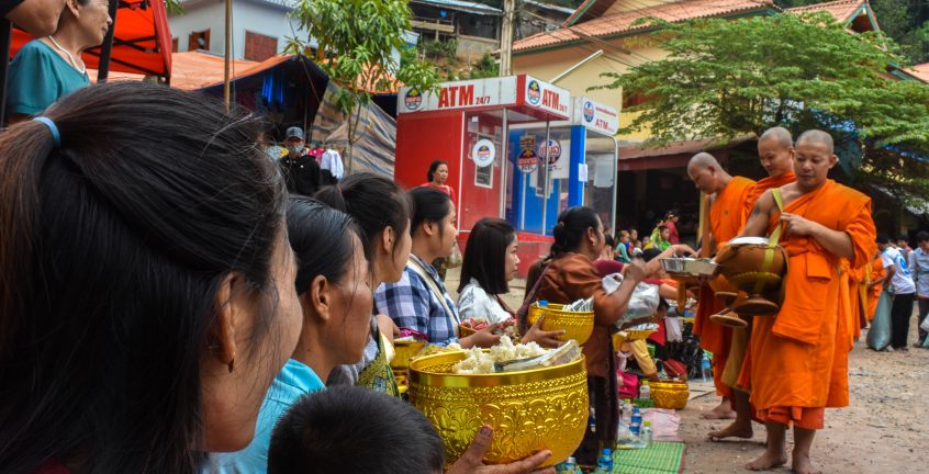 Novice Monks is chanting and blessing local villagers who offered alms